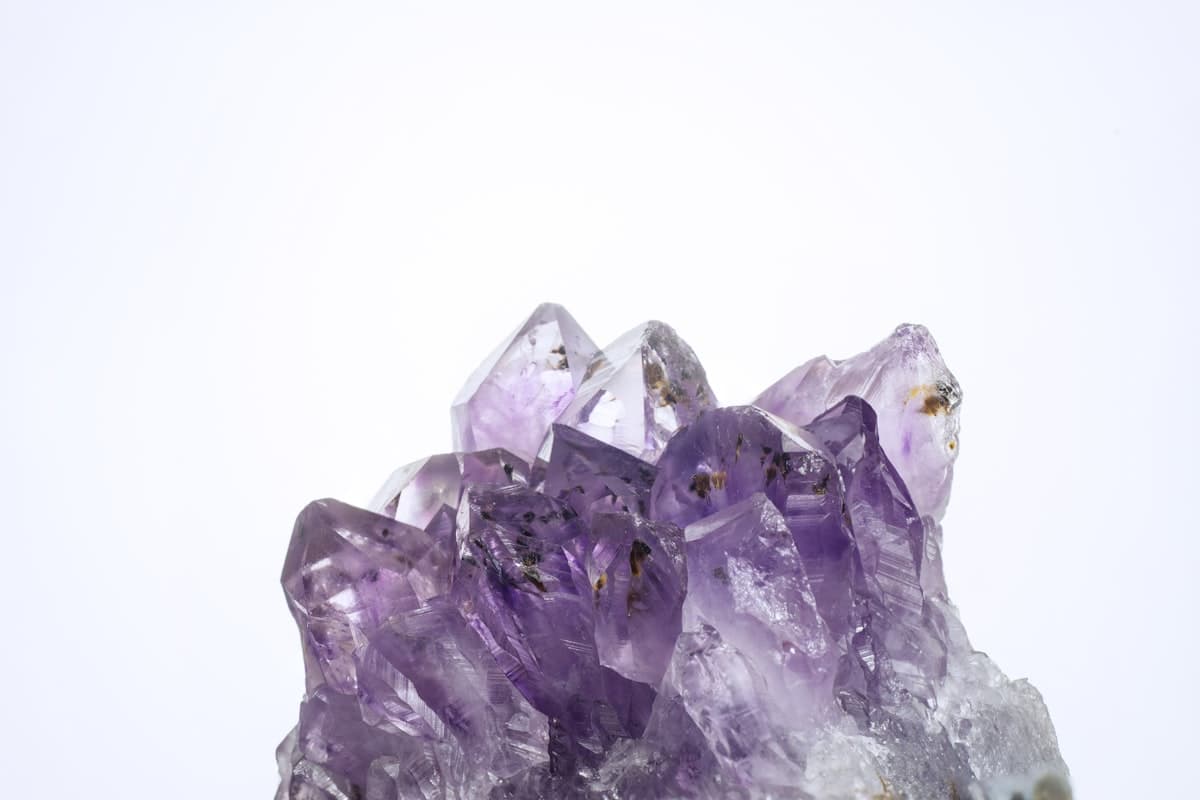 A faceted purple gemstone geode formation